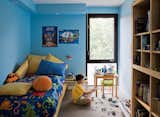 Kids, Bedroom, Boy, Pre-Teen, Desk, Bed, Night Stands, Chair, Carpet, Shelves, and Storage Griffin’s room, which is exactly the same size as his brother’s, gets good light from the backyard.  Kids Storage Bed Chair Shelves Photos from Narrow Modernist Three-Story Home in Toronto