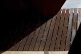 Rocks and earth are visible between the steel blades one as visitors walk down the path. In the dark lower areas of the structure, daylight creeps in through cracks between earth and steel.  Search “between earth and heaven architecture john lautner” from La Bodega Winery in Palamos, Spain