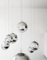 Bruce worried about what to put in the double-height space above the kitchen table—–until he found these Tom Dixon–designed mirror balls. "They were installed at random and when William came over that evening, he said, ‘Fantastic, well done.’ So we left them like that."
