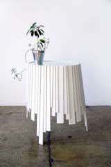 The Matryoshka series is defined by overlapping wooden slats, as though paint had dripped down the side of this end table, drying in rectangular globs.
