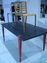 This piece, by Philippe Nigro for Ligne Roset, is called the Table Universelle. The adjustable legs, constructed of laser-cut and folded steel, are available in red, white or black lacquer, and can fit any tabletop.