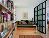 Inside the library is a wall of books and spots to lounge. Photograph by Paul Warchol.