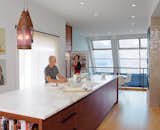 Vintage pendants cast a soft glow over the island, which contains a Bosch dishwasher.