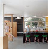 The “murdered kitchen” includes a fluorescent light sculpture with dimmable ballasts designed by Bestor. The rough plywood offers a nice chromatic contrast.