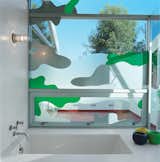 Los Angeles–based graphic designer Chris Loomis created a trio of window

decals for the house’s three bathrooms. Grunbaum went with a camouflage pattern for privacy in the master bathroom, which has a wall of floor-to-ceiling glass that looks onto an adjacent patio. “Because we’re sort of in the trees, I wanted to keep the plant theme going,” he says. laloomis.com  Photo 6 of 8 in Homes with Unusual Windows by William Harrison from Daft Punk Could Play at This House