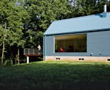 Exterior, House Building Type, Metal Roof Material, and Metal Siding Material The floor-to-ceiling living-room window was inspired by Philip Johnson’s Glass House.  Photo 6 of 10 in Bringing It All Back Home