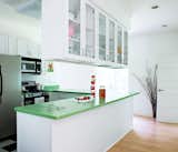 A leaf-green countertop adds a splash of color to the kitchen.