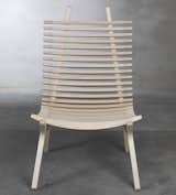 The IBBI lounge chair by designer Nils Gulinis features two distinct parts— Mirror-image frame supports, which give the chair shape, and 29 sculpted laths that cradle the body, providing the chair with beautiful lines from every perspective. IBBI also has a thin seat pad for comfort, and a headrest available.