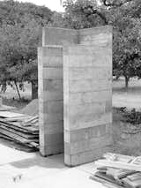 By using the units repeatedly, the architects saved on cost and materials as well as scaling the work to be manageable with one concrete truck and a two-person crew. The resulting facades are textured from the rough wooden planks.  Photo 7 of 23 in Fertile Grounds
