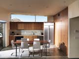 One large room houses the kitchen, dining, and living area, the backsplash and countertops are made by Vetrazzo.  Photo 4 of 10 in Small “Hybrid Prefab” Home in the Desert