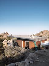 As a paean to the old steel-mining shacks that inspired the home, McAdam sprayed the the corrugated-steel exterior with apple cider vinegar to create a warm rust effect.  Photo 9 of 10 in Small “Hybrid Prefab” Home in the Desert