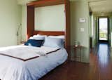 The bed folds vertically into the wall to open up the living space for lounging or entertaining.  Photo 6 of 10 in A Modern Coastal Home in Stinson Beach