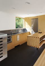 The stainless-steel-and-maple kitchen, which was completely pre-built as part of the module before being plopped onto the site, has a Flor-Gres recycled porcelain tile floor.