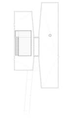 The retreat, which was manufactured by Kullman Buildings (founded in 1927 for the purpose of building prefab steel-and-glass diners), takes on an X formation, with one end of the X equipped with floor-to-ceiling glass windows overlooking the water. "It’s quite a bucolic site," says Garrison. "We related the building to both the lake and the gentle slope of the land, and created an opening in the center of the X that makes the building seem larger and allows reflective light in."