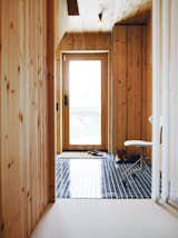 Doors, Exterior, Wood, and Swing Door Type Though the house is a mostly wooden affair, a sense of transparency pervades, thanks to many windows and the glass front door.  Photo 6 of 10 in Modern Entrance Halls  by Erika Heet from Knotty by Nature