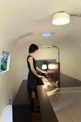 The table tops fold up to reveal part of the beds and the tucked-away reading lamps. Photo by Sadamu Saito.  Photo 7 of 10 in Hide and Sleep