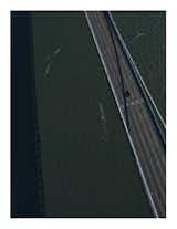 Titled "San Francisco," this aerial view of what is likely the Bay Bridge shows the kind of gritty, lonely weight our infrastructure has to pull.