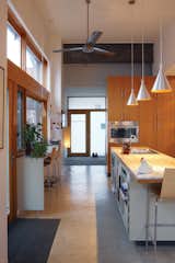 The kitchen, which gets light from three sides, welcomes guests into the house.