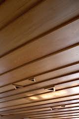 The cedar weatherboard ceiling in the living pavilion features triangular recesses for lightbulbs.  Photo 19 of 27 in Ceiling by Casey Tiedman from The Great Compression