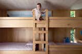 Kids Room, Bedroom Room Type, and Bunks In the kids’ room, Seamus climbs the bunk beds he shares with his siblings.  Photo 7 of 14 in Neskowin by Eileen Crimmins from The Great Compression