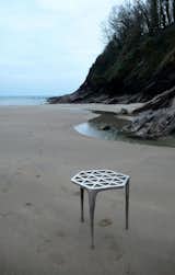 Max Lamb's pewter stool is cast from a formwork of wet sand on the beaches of Cornwall, England.  After digging the three legs and hexagonal structure plate into the sand, he poured molten pewter into the mold cavity, and when it set, dug out the stool. (This process is beautifully documented on video.)