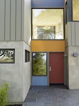 This entryway also has that sense of colorful play while receding into the facade of the house.