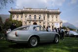 A 1954 Alfa Romeo 2000 Sportiva is framed by Villa Erba. Before the war, the villa was host to extraordinary parties with notable guests, artists and personalities from the political and industrial worlds.