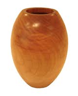 Etel Carmona creates her Bojudo vase (which roughly translates to "rounded")  from the trunks of fallen native Brazilian trees. In each vase, as in this cedar example, Carmona celebrates the natural cracks and grain of the wood, resulting in one-of-a-kind pieces.