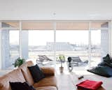 The living room receives ample light through the south-facing glass doors and floor-to-ceiling windows.