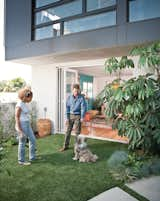 They installed water-saving artificial grass on their patio for pup Moxy to enjoy.