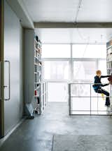 Dulkinys uses the remote-controlled mountaineer’s harness to peruse the two-story bookshelf.