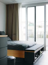 The interior is bright and charming, cool but not cold. Each floor is open, with an unencumbered view from the glass facade in front to the glass doors in back, which makes the rooms feel much larger than they are.