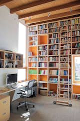 Office, Library Room Type, Bookcase, Shelves, Desk, and Chair Dan Garness used paint and well-placed windows to keep Duane’s office bright and airy.  Photo 3 of 5 in Rolling Ladders in Modern Homes by Zach Edelson from Coast Docs