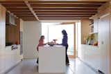 Kitchen Carole and granddaughter Allison—–silhouetted against a glass door that pivots open to the front garden—–plot how they’ll prepare the family’s next meal at the kitchen island.  Search “epic plot” from Coast Docs