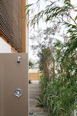After a day at the beach, an outdoor shower tucked toward the back of the house allows everyone to rinse off without tracking sand indoors.