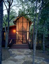 The architectural relationship between the bunkroom and porch, and the bunkhouse and the surrounding forest, is especially apparent at dusk, when the building reads as a kind of illuminated lantern.