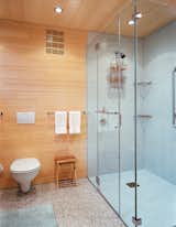 Bath Room, Terrazzo Floor, One Piece Toilet, Recessed Lighting, Enclosed Shower, and Ceramic Tile Wall The floors, walls, and ceilings are coated in FSC-Certified laminated bleached bamboo.  Photo 4 of 6 in eR by Dusko Amrich from A Striking Angular Cottage in Connecticut