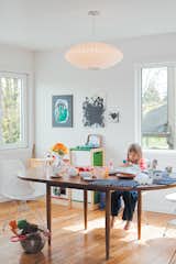Daughter Zoë finds a cozy spot at the dining-room table, by Dux, seated on an Eames Molded Plastic chair and under a George Nelson Saucer lamp.  Photo 2 of 10 in Z for Two