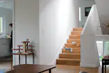 “To maintain the seamless connection from room to room, it was important that the flooring material was the same throughout the house,” Waechter says. “We took that continuity down to the smallest detail, eliminating the nosing so the treads look like a folded floor rather than a stair made up of treads and risers.”  Photo 9 of 10 in Z for Two
