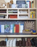 Tableware shares space with a curated collection of books, tea towels, and treasures for the home.