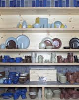 A tableau of tableware at the Ferry Building location shows the range of glaze options and styles of stoneware available. This year’s summer collection is featured on the top shelf, above platters, mugs, bowls, and a small teapot from the traditional Coupe line on the second shelf from the top. Dessert bowls, salt and pepper shakers, pitchers, pasta bowls and more round out the display.