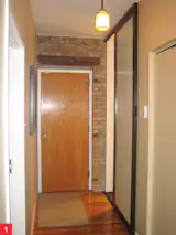 Anti-Pocket Door

Submitted by: Name not provided

Designer's Description: 

Purchasing a vintage rehabbed condo has its drawbacks when the space is not fully functional. A small Chicago urban setting, small condominiums cannot afford any inefficiency in the little things, like a door swing. A traditional pocket door is not feasible due to the plumbing chase in the location where the pocket would be housed.  The bathroom door swing's reversal is not ideal due to the proximity of the entry door's swing. The only viable solution is an externally mounted sliding door.