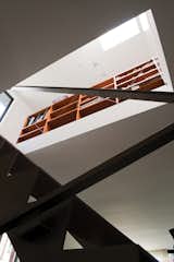 Looking up to the second level of the Brookfield House, where a mobile hangs from the ceiling.