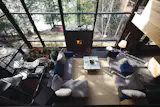Daoust's living room features an indoor geranium garden, and is centered around a large fireplace.