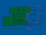 The floor plan reveals the existing house, in green, and the addition, bordered in red. The angle of the lantern "was a pretty intentional shift on our part," says Misra. "First we had it parallel to the barn on plan, but we tweaked it a little and gave it an angle, because when standing on the patio and looking out to the pool, the sightline is best this way. In a parallel format, the patio and pool felt a little close, and this way we were able to maximize the spacious feeling by playing with the angles slightly." Image courtesy Chinmaya + Apurva: Collaborative