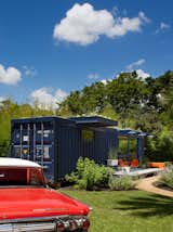 Hill’s 1962 orange Mercury Monterey complements the blue of the container, whose original opening was retained on one end as the entrance to the garden storage shed.