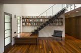 Particularly fond of careful detail, Alter designed the treads of the entryway staircase to merge seamlessly into the adjacent bookshelves. “I enjoy doing things that make you wonder about the context and look a little further,” he says.  Photo 7 of 10 in Modern Renovation in Austin by Wilson Barr