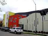 Bright colors, contemporary detailing, and plays on mass and void are seen throughout the development. The high-density apartment building on the southeastern corner of the site reflects some of the unique architectural features of the project. The US Green Building Council awarded the apartment building a LEED for Homes Platinum rating.