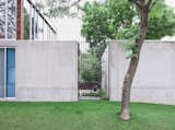 A tall steel gate grants entry to the courtyard.