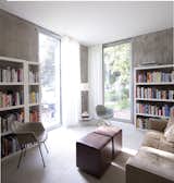The study houses not only a pair of plastic Eames shell chairs but much of the couple's large collection of architecture and design books.  Photo 20 of 29 in Living by Tony Mendoza from Modern Urban Retreat in South Minneapolis